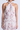 Woman wearing a floral halter neck dress on a white background