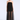 A woman modeling a strapless black tulle dress with a sheer overskirt and black strappy high-heeled sandals against a light gray studio background.