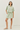 Woman wearing a light green striped outfit on a white background