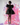 Model wearing a dark textured dress with puff sleeves against a colorful abstract background