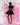 Woman in a black dress standing against a colorful abstract background
