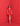 Woman in a red dress standing against a red wall
