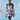 Model wearing a purple and white patterned dress against a light blue background