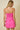 Woman wearing a pink strapless dress against a beige background