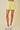 Yellow lace shorts worn by a person on a beige background