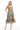 Woman wearing a floral strapless dress on a white background