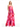 Woman wearing a strapless, pink tie-dye dress on a white background