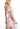 Woman wearing a colorful floral dress on a white background