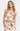 Woman wearing a floral dress with red accents on a white background