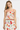 Woman wearing a floral two-piece outfit on a white background