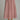 A pink and burgundy polka dot midi skirt with a gingham texture, shown on a model from the waist down wearing gold flat shoes against a neutral gray background.