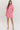Woman wearing a pink outfit with a white background