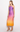 Woman wearing a gradient dress transitioning from purple to orange on a white background