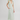 Woman wearing a light green dress with a white background