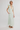 Woman wearing a light green dress with a white background