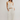 Woman wearing cream linen pants.