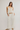 Woman wearing cream linen pants.