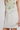 White dress with floral embroidery on a plain background
