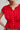 Red top with lace details and white buttons on a plain background