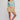 Woman wearing a light blue sweater and checkered shorts on a white background