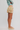 Person wearing a colorful striped skirt on a plain background