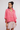 Woman wearing a linen oversized top in tart berry.