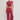 A model wearing a matching dusty rose two-piece lounge set consisting of a sleeveless crop top and wide-leg sweatpants, paired with white sneakers, against a plain light gray studio background.