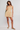 Woman wearing a yellow and white striped dress on a white background
