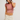 Woman wearing a pink crop top and beige pants on a plain background