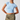 Woman wearing a light blue crop top and green skirt on a white background
