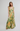 Woman wearing a floral dress with yellow and green pattern on a white background