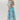 Woman wearing a floral dress with a light blue background