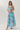 Woman wearing a floral dress with a light blue background