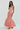 Woman wearing a red and white striped dress on a white background