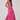 Woman wearing a pink dress on a white background