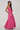 Woman wearing a pink dress on a white background