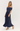 Woman wearing a navy off-shoulder gown on a white background