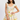 Woman wearing a floral dress on a plain background