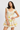 Woman wearing a floral dress on a plain background