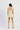 Woman wearing a floral dress and beige knee-high boots on a white background