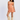 Woman wearing an orange patterned dress and beige knee-high boots on a white background
