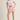 Woman wearing a pink t-shirt and shorts with a white background