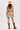 A woman shown from the back wearing a sleeveless tiered mini dress with a beige and brown floral print, a matching belt, a straw cowboy hat, and brown cowboy boots against a plain white studio background.