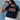 Woman wearing a navy t-shirt with 'USA' text, white cap, and light pants against a blue textured background
