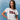 Woman wearing a white t-shirt with 'USA' printed on it against a blue background