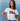Woman wearing a white t-shirt with 'USA' printed on it against a blue background