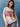 Woman wearing a beige sweater with an American flag design against a blue background