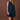 A woman modeling a sleeveless dark blue denim shirt dress with front buttons and flap pockets, standing against a solid brown studio backdrop.