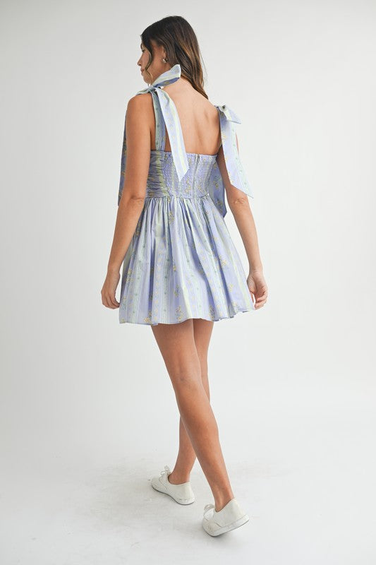 FLORAL RUCHED MINI DRESS WITH SHOULDER TIE IN LAVENDER