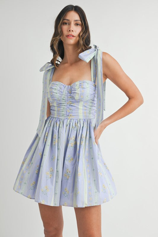 FLORAL RUCHED MINI DRESS WITH SHOULDER TIE IN LAVENDER